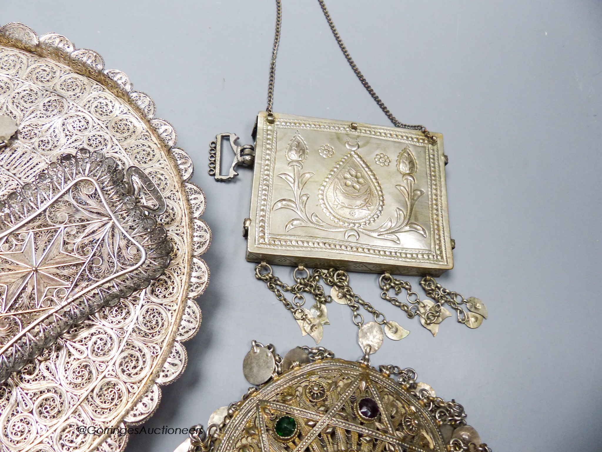 Two Middle Eastern white metal filigree trays, largest 24cm and two other Middle Eastern items.